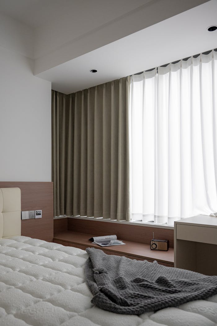 Elegant minimalist bedroom interior design with soft lighting and cozy atmosphere.